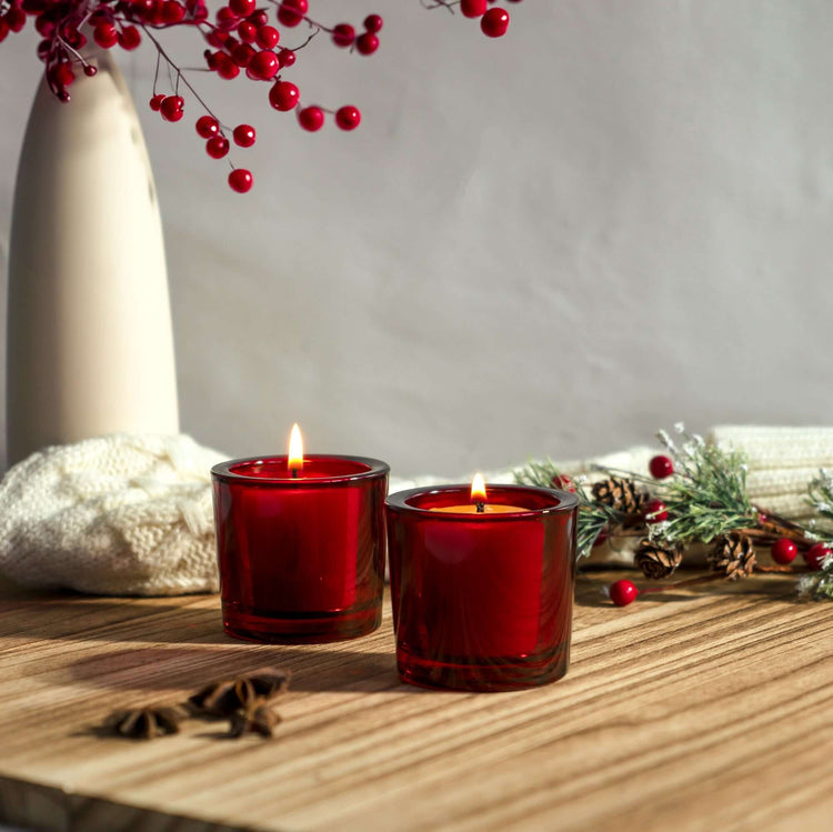 bluecorn beeswax votive candles in bright red glass candle holders