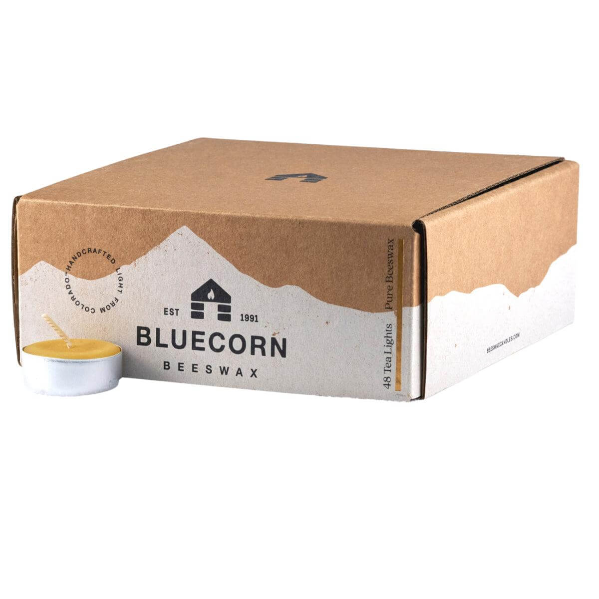 Bluecorn Beeswax 100% Pure Beeswax 48 Pack Raw Tea Light in Metal Cups. Picture features one Tea Light outside of Bluecorn branded Tea Light Box with a white background. Box features Bluecorn Beeswax name and logo, with an outline of Mt. Wilson in white printed on a 100% recycled kraft paper box. beeswax tealight candles burn for about 5 hours each.