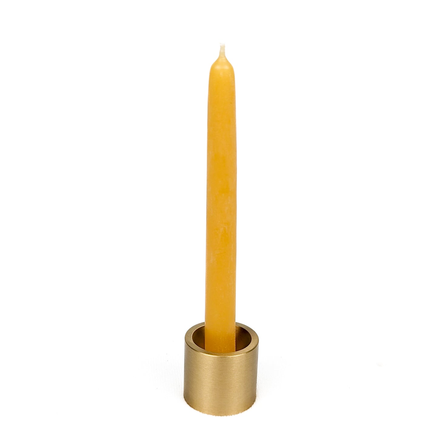 a pure beeswax taper in a solid brass holder from bluecorn candles