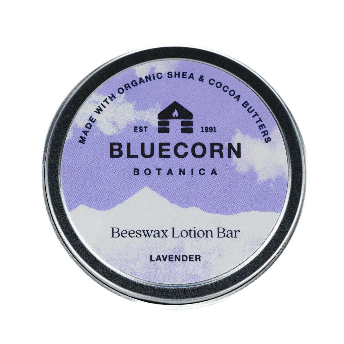 Bluecorn Botanica Beeswax Lotion Bar in Lavender. Made with Organic Shea Butter, Organic Cocoa Butter, Avocado Oil, Apricot Oil, Cappings Beeswax, Essential Oils. Using the warmth of your hands, these solids bars will turn into lotions. Can be used all over the body and come in a convenient tin. Features Purple Bluecorn Botanica Label on aluminum tin.