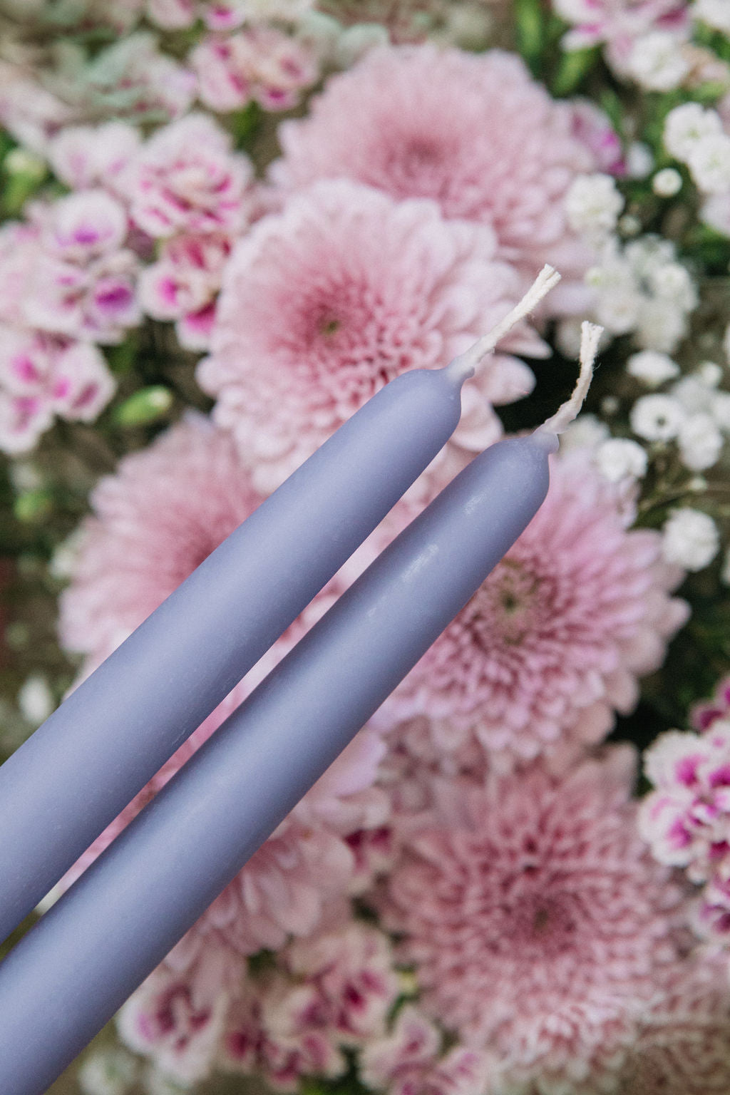 lilac beeswax taper candles over pink flowers spring candles bluecorn
