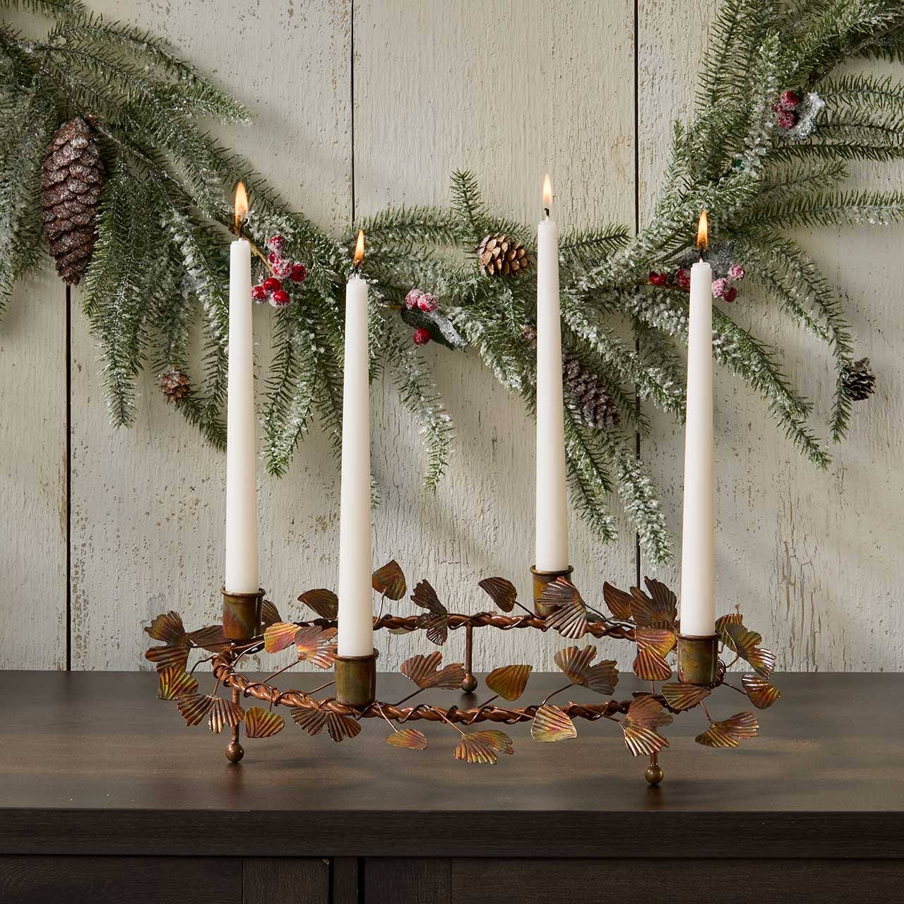 Ginkgo Advent wreath taper candle holder displayed as a glowing holiday centerpiece with lit taper candles in a home setting