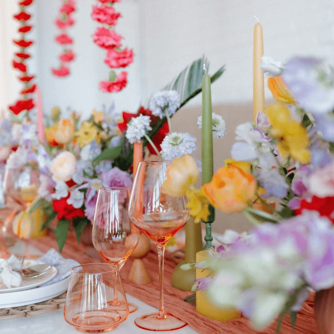 colorful spring table with green taper candle and pure beeswax taper candle