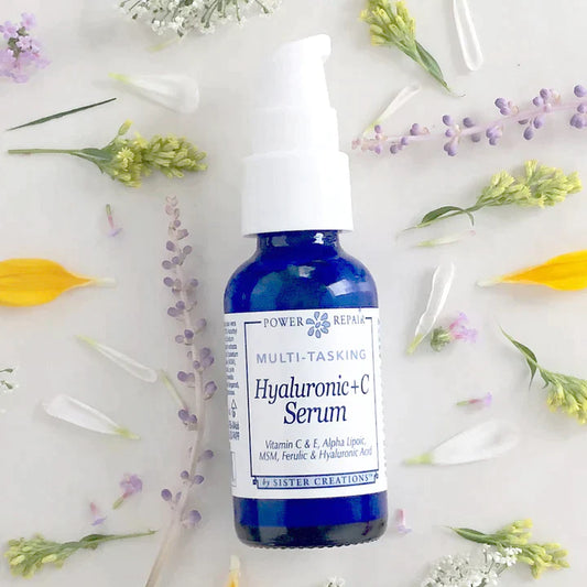 Hyaluronic acid and vitamin C serum bottle on a white background