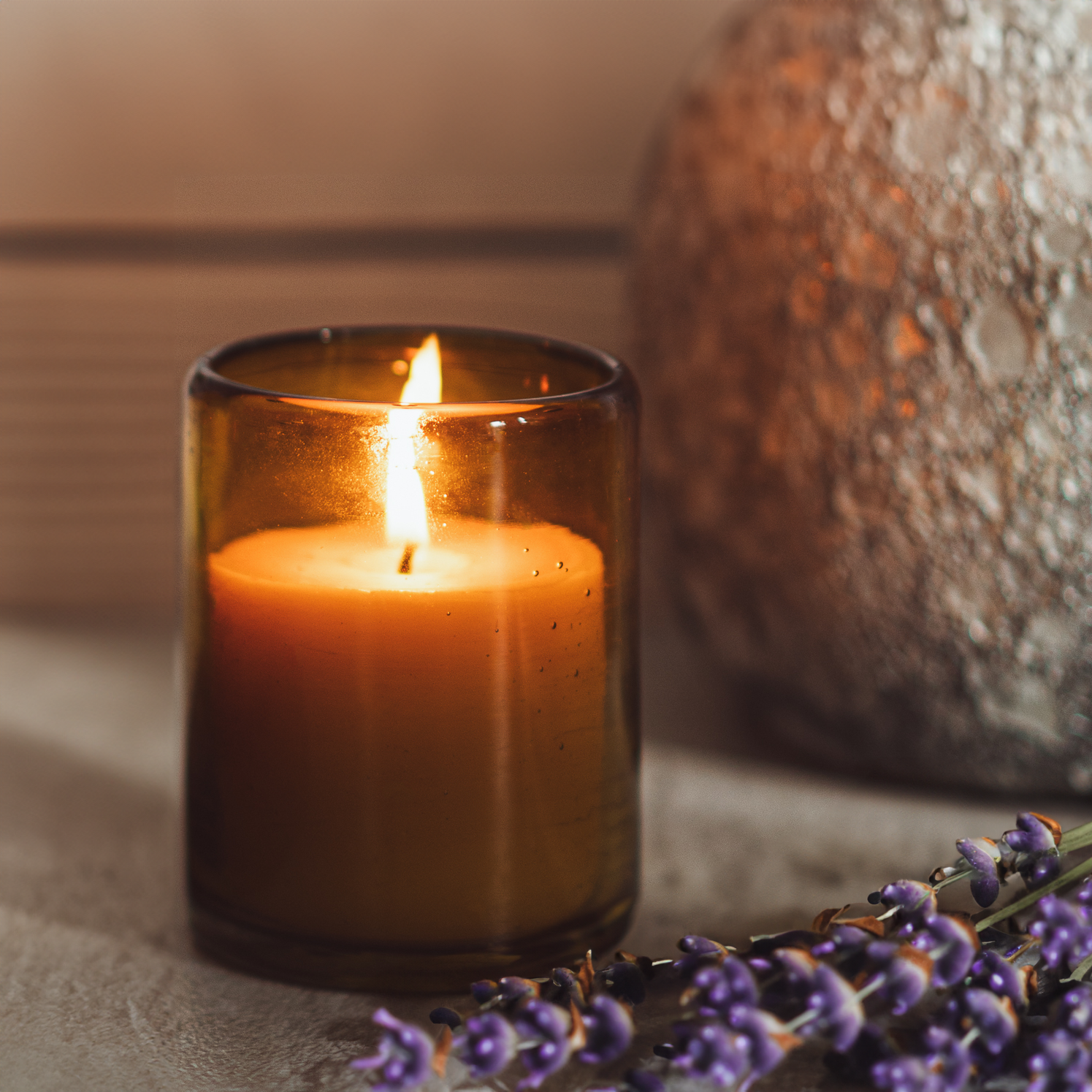 small bluecorn botnica beeswax candle made from pure beeswax and lavender essential oil in a blown glass candle holder