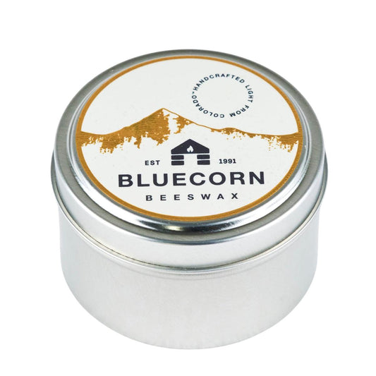 Bluecorn Beeswax Raw Beeswax Travel Tin 6oz Candle. Handmade in Montrose, CO. Paraffin and Lead free and made with a cotton wick. Burn time 30 hours. Candle Dimensions: 2.75in (dia.) x 1.75in (ht.). Wax is golden in color and packaging features a white and gold foil sticker with the Bluecorn Logo. Great For: Traveling, Camping, Hotel Rooms, Gifts. Metal tins are recyclable or can be repurposed and reused. We do not take the tins back after the candle is burned. 