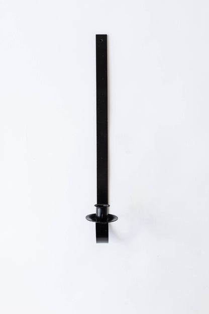 Black iron wall-mounted tapers for candles holder on a white background. Hand-forged by Amish artisans for Bluecorn Candles.