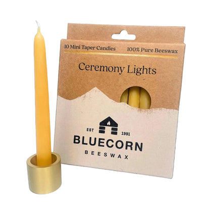 Beeswax candle with packaging labeled 'Bluecorn Beeswax' on a white background