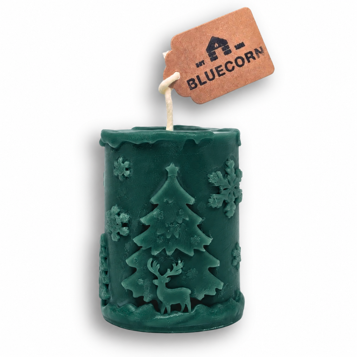 Forest green beeswax Christmas pillar candle with a raised winter scene of Christmas trees, reindeer and snowflakes.
