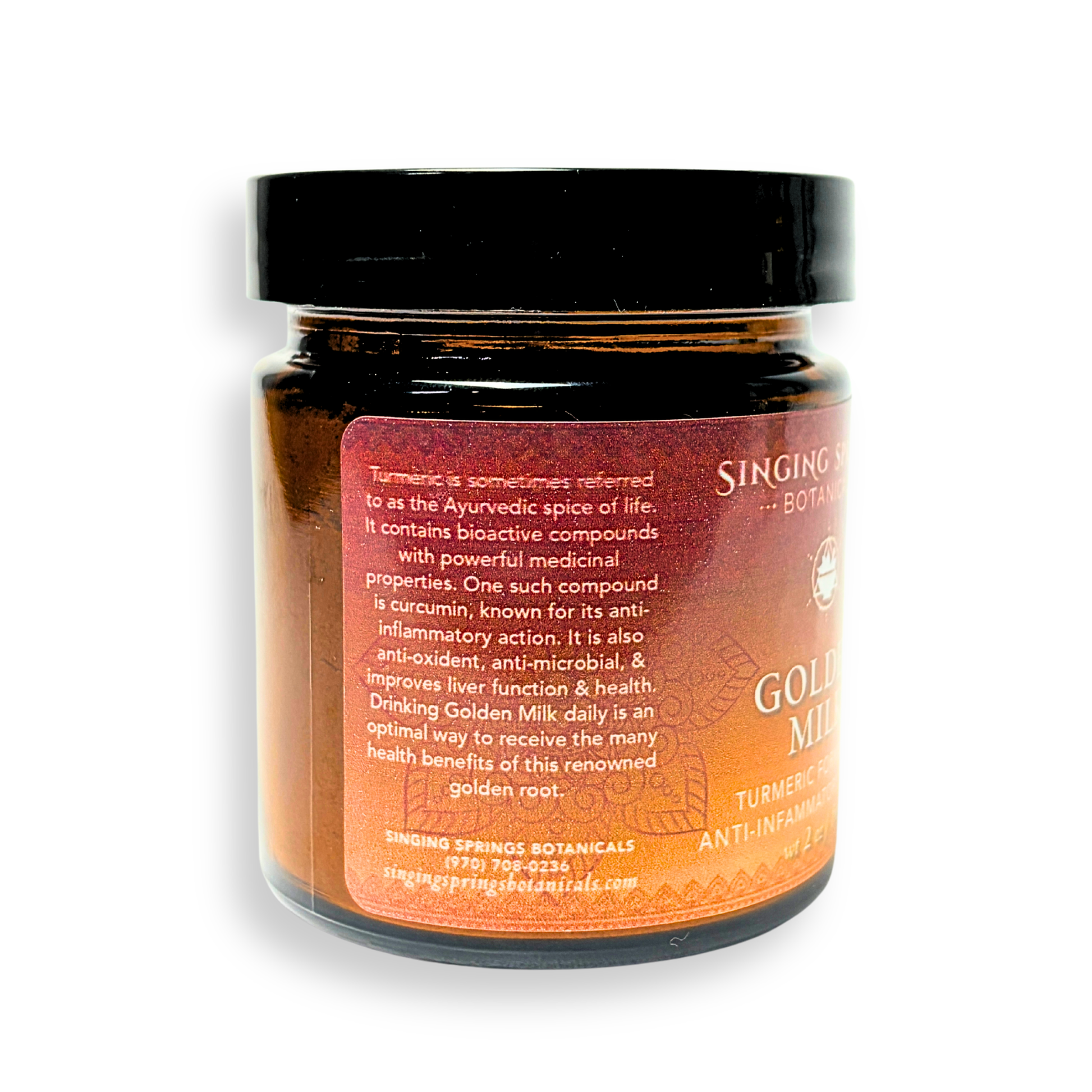 Jar of 'Gold Milk' with a black lid on a white background