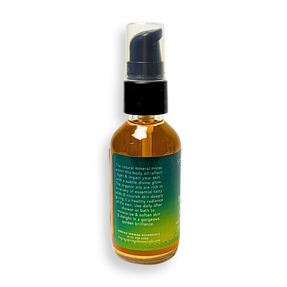Bottle of body oil with a pump on a white background