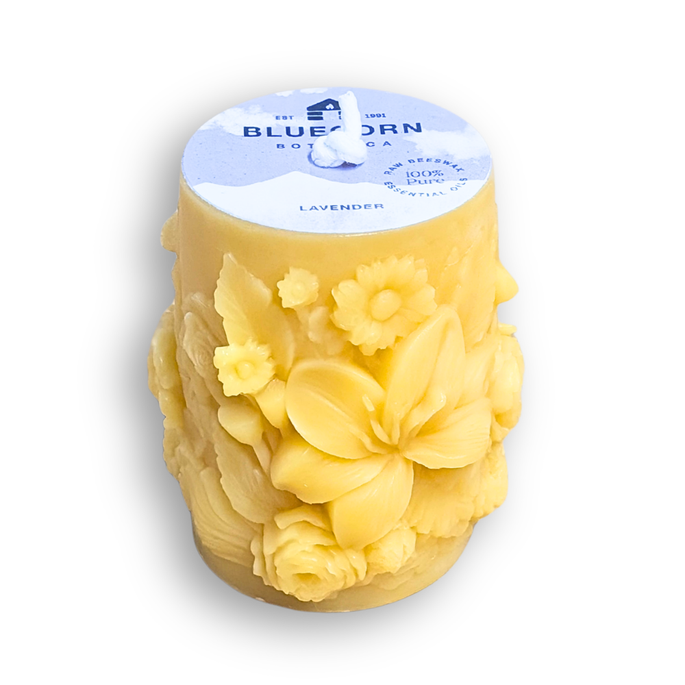 Lavender scented sculpted beeswax pillar candle with white background
