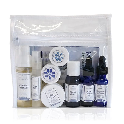 Set of skincare products in a clear pouch on a white background