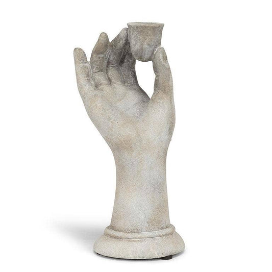 Decorative stone hand holding a small cup on a white background