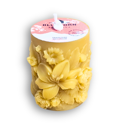 Tangerine & Geranium scented sculpted beeswax pillar candle with white background