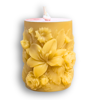 Yellow floral beeswax pillar candle on a white background