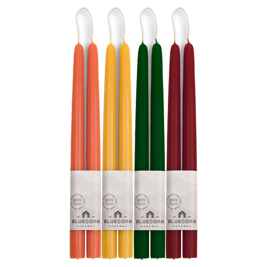 Bluecorn beeswax taper candles in a range of jewel tones for autumn - burnt orange, gold, dark green and burgundy candlesticks