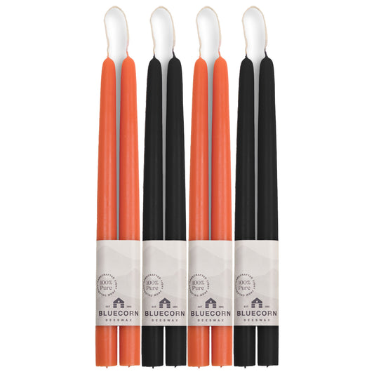 two pairs each of orange candles and black taper candles from bluecorn candles made with pure beeswax in colorado