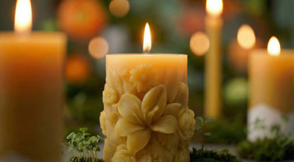 decorativ floral beeswax candle with other beeswax pillars and tapered candles in the background