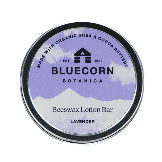 Bluecorn Botanica Beeswax Lotion Bar in Lavender. Made with Organic Shea Butter, Organic Cocoa Butter, Avocado Oil, Apricot Oil, Cappings Beeswax, Essential Oils. Using the warmth of your hands, these solids bars will turn into lotions. Can be used all over the body and come in a convenient tin. Features Purple Bluecorn Botanica Label on aluminum tin. 