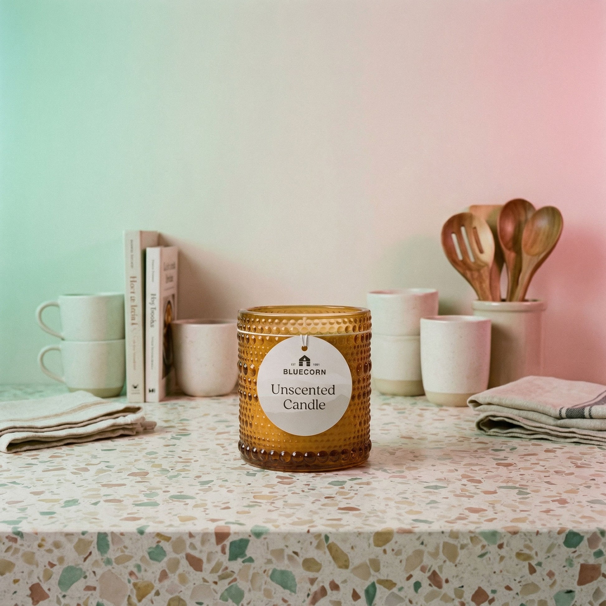 Unscented refillable candle in knobby amber glass with warm candlelight glow