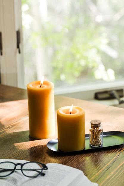 bluecorn beeswax pillar candles on metal tray 
