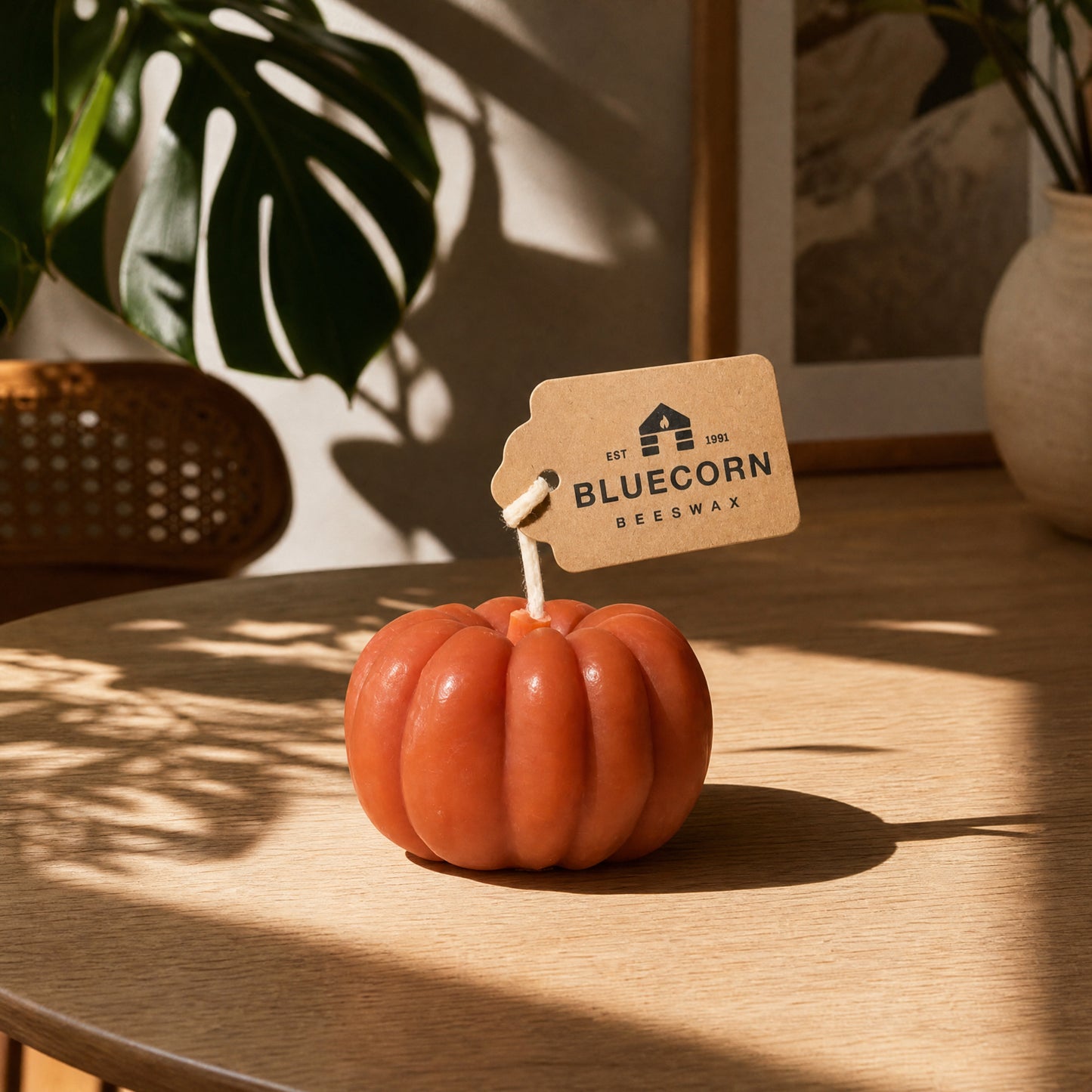 Scented beeswax pumpkin candle from Bluecorn Candles in a fall decor setting
