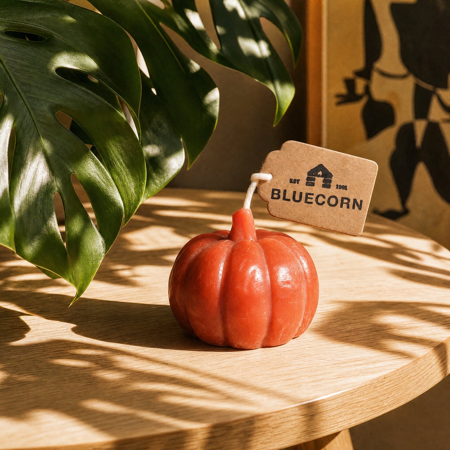 Beeswax pumpkin candles in terracotta, black and lilac styled with fall decor