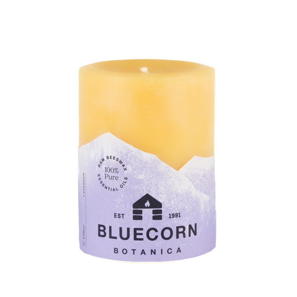 Bluecorn Botanica 100% Pure Beeswax Lavender 3" x 4" Scented Pillar Candle. Burn Time: 60 hours. Made with 100% Pure Beeswax, 100% Pure Essential Oils, and a 100% pure cotton wick, no lead. Candles are paraffin free, clean burning and non-toxic. Features Bluecorn Botanica label in purple printed on 100% recycled paper. Wax is golden in color. 