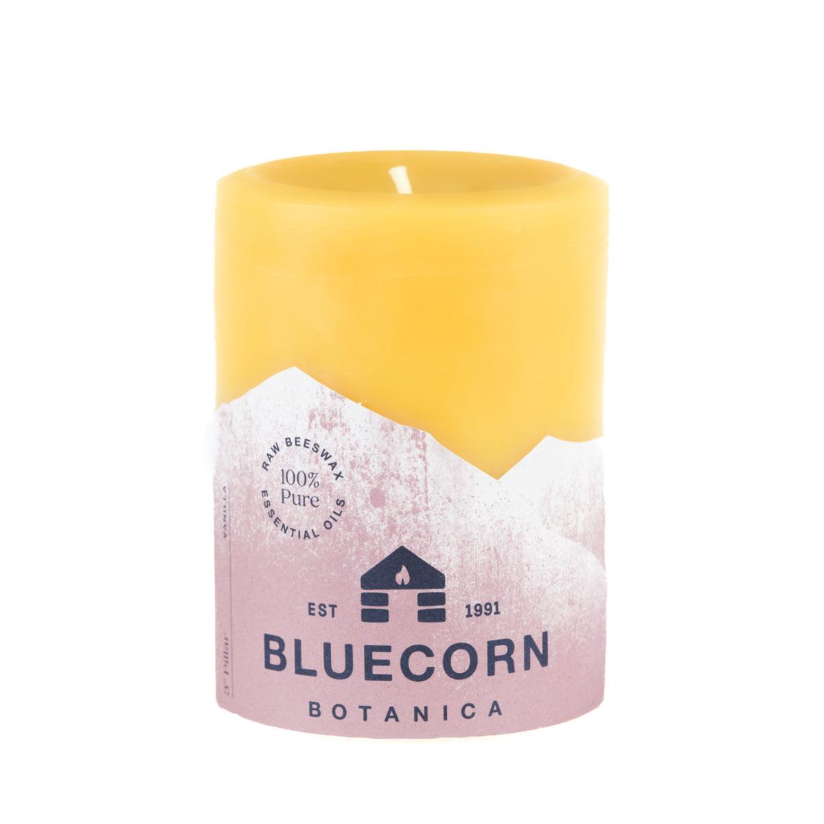 Bluecorn Botanica 100% Pure Beeswax Vanilla 3" x 4" Scented Pillar Candle. Burn Time: 60 hours. Made with 100% Pure Beeswax, 100% Pure Essential Oils, and a 100% pure cotton wick, no lead. Candles are paraffin free, clean burning and non-toxic. Features Bluecorn Botanica label in Brown printed on 100% recycled paper. Wax is golden in color. 