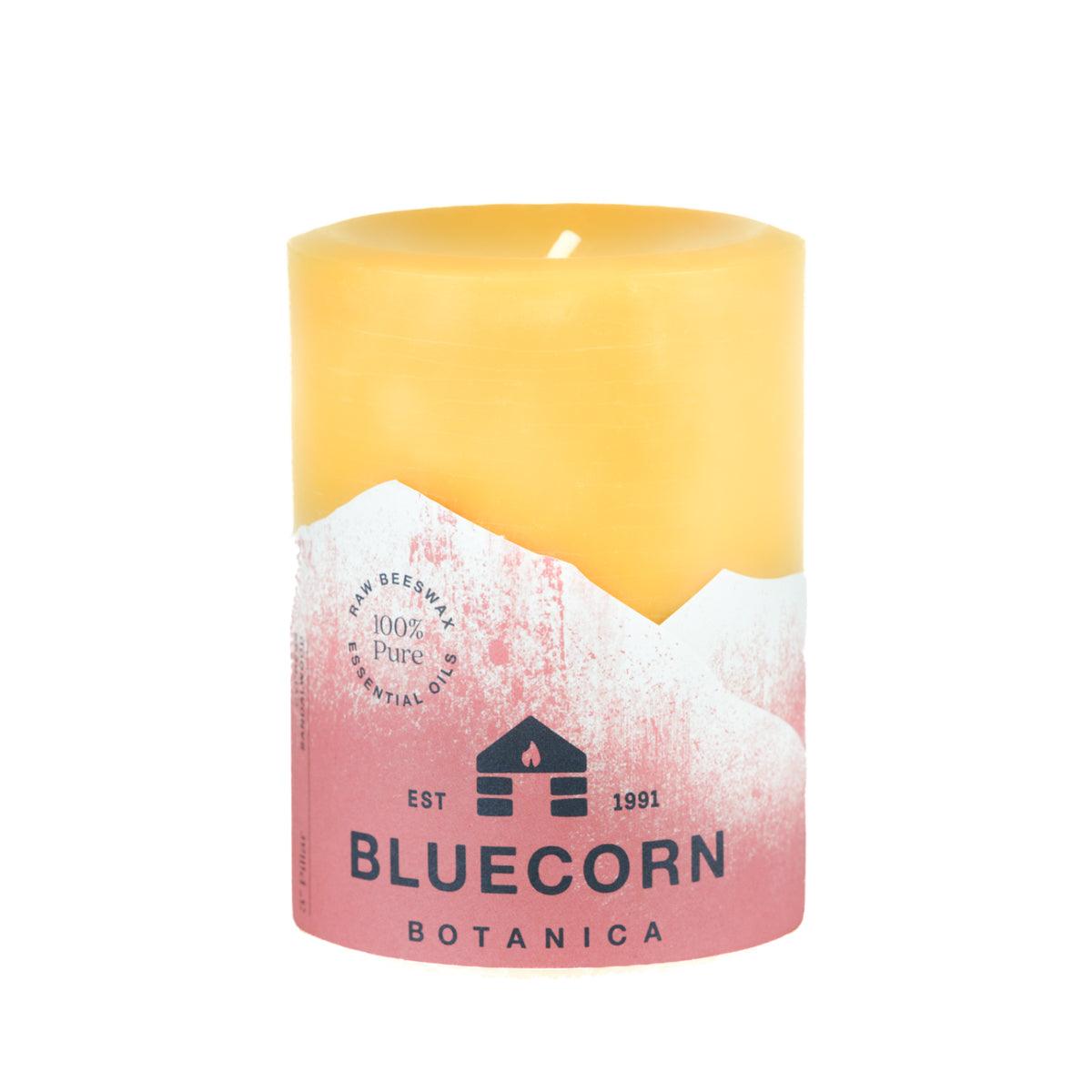 Bluecorn Botanica 100% Pure Beeswax Cypress and Sandalwood 3" x 4" Scented Pillar Candle. Burn Time: 60 hours. Made with 100% Pure Beeswax, 100% Pure Essential Oils, and a 100% pure cotton wick, no lead. Candles are paraffin free, clean burning and non-toxic. Features Bluecorn Botanica label in Red printed on 100% recycled paper. Wax is golden in color. 