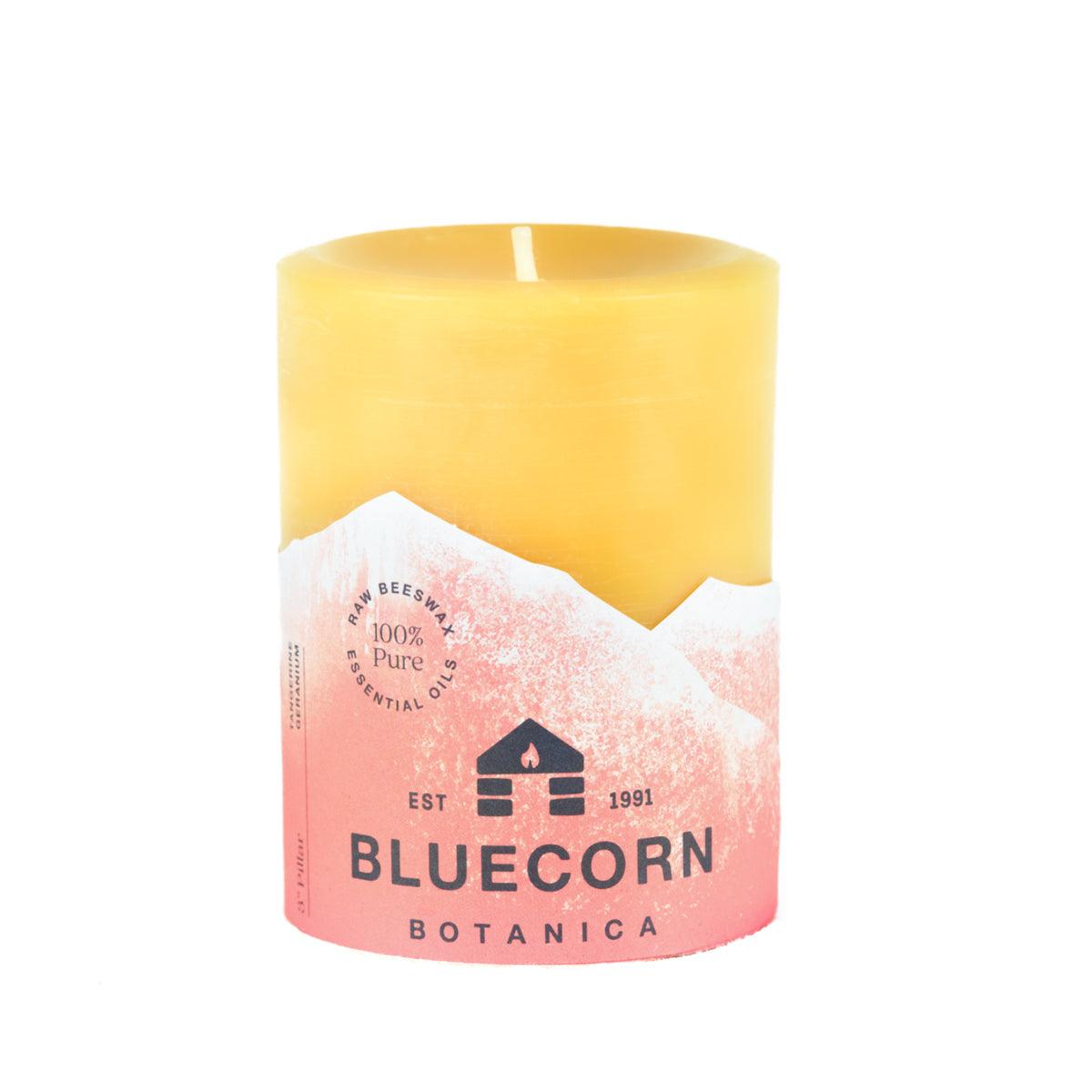 Bluecorn Botanica 100% Pure Beeswax Tangerine and Geranium 3" x 4" Scented Pillar Candle. Burn Time: 60 hours. Made with 100% Pure Beeswax, 100% Pure Essential Oils, and a 100% pure cotton wick, no lead. Candles are paraffin free, clean burning and non-toxic. Features Bluecorn Botanica label in Orange printed on 100% recycled paper. Wax is golden in color.