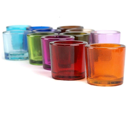 An array of recycled glass candle holders in a rainbow of colors