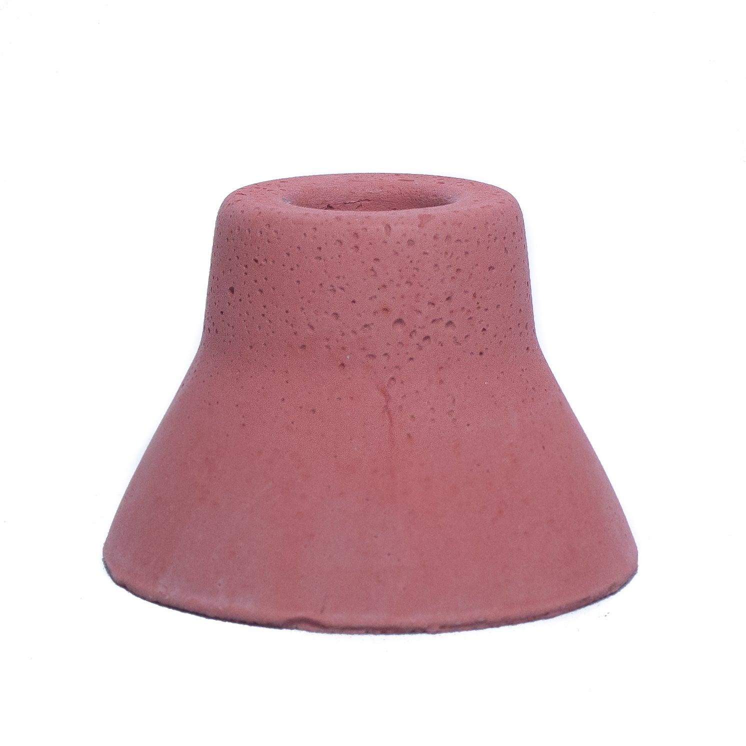 Terracotta concrete taper candle holder. 3" wide at the base, 2" high. Holder narrows toward the top to fit Bluecorn Beeswax's standard taper holder.
