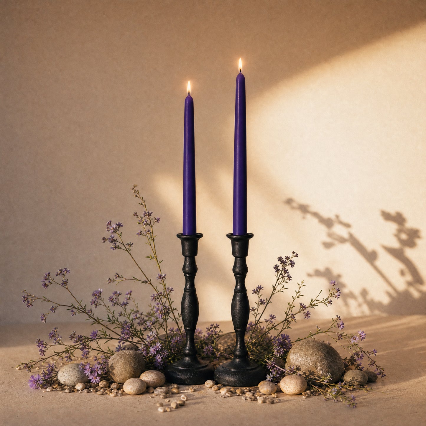 dark purple tapered candles in cast iron candle holders