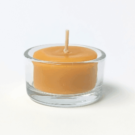 bluecorn beeswax tea light burning in a refillable glass tea light holder