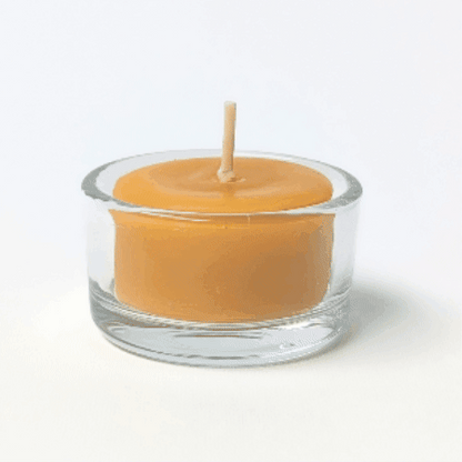 bluecorn beeswax tea light burning in a refillable glass tea light holder