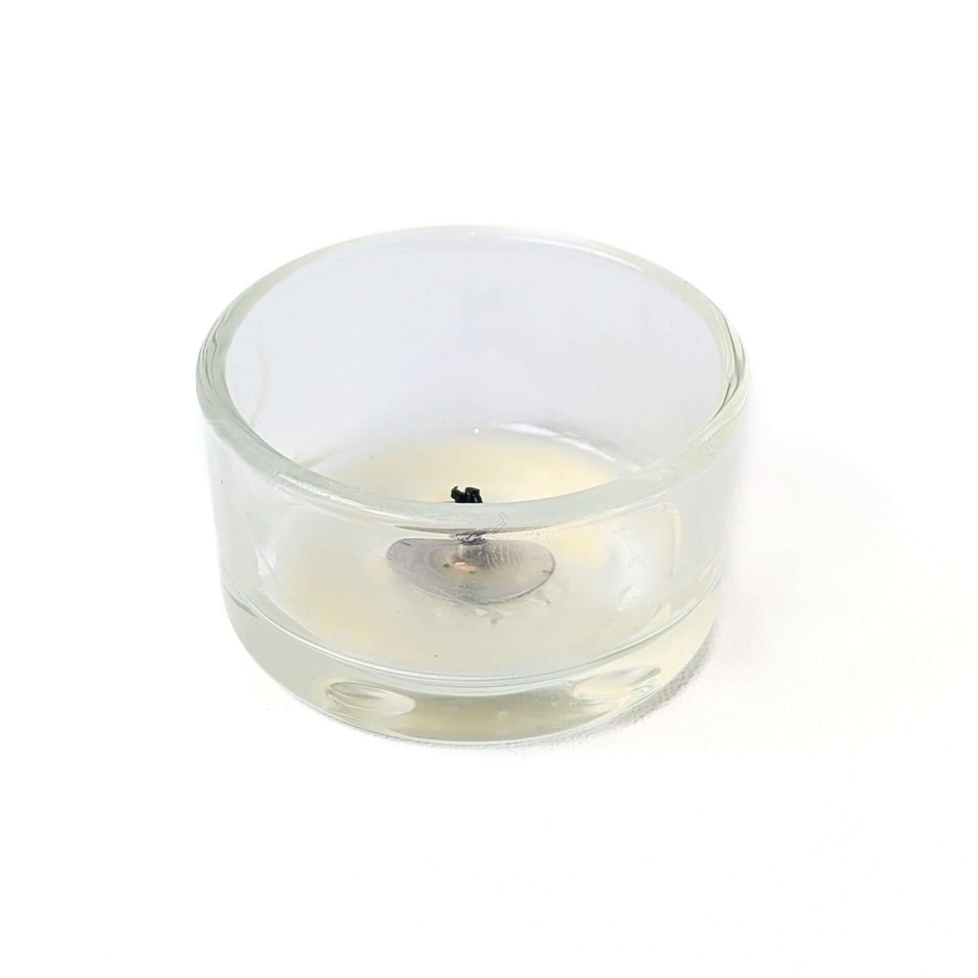 empty beeswax tea light glass holder with very little leftover wax after a super efficient burn