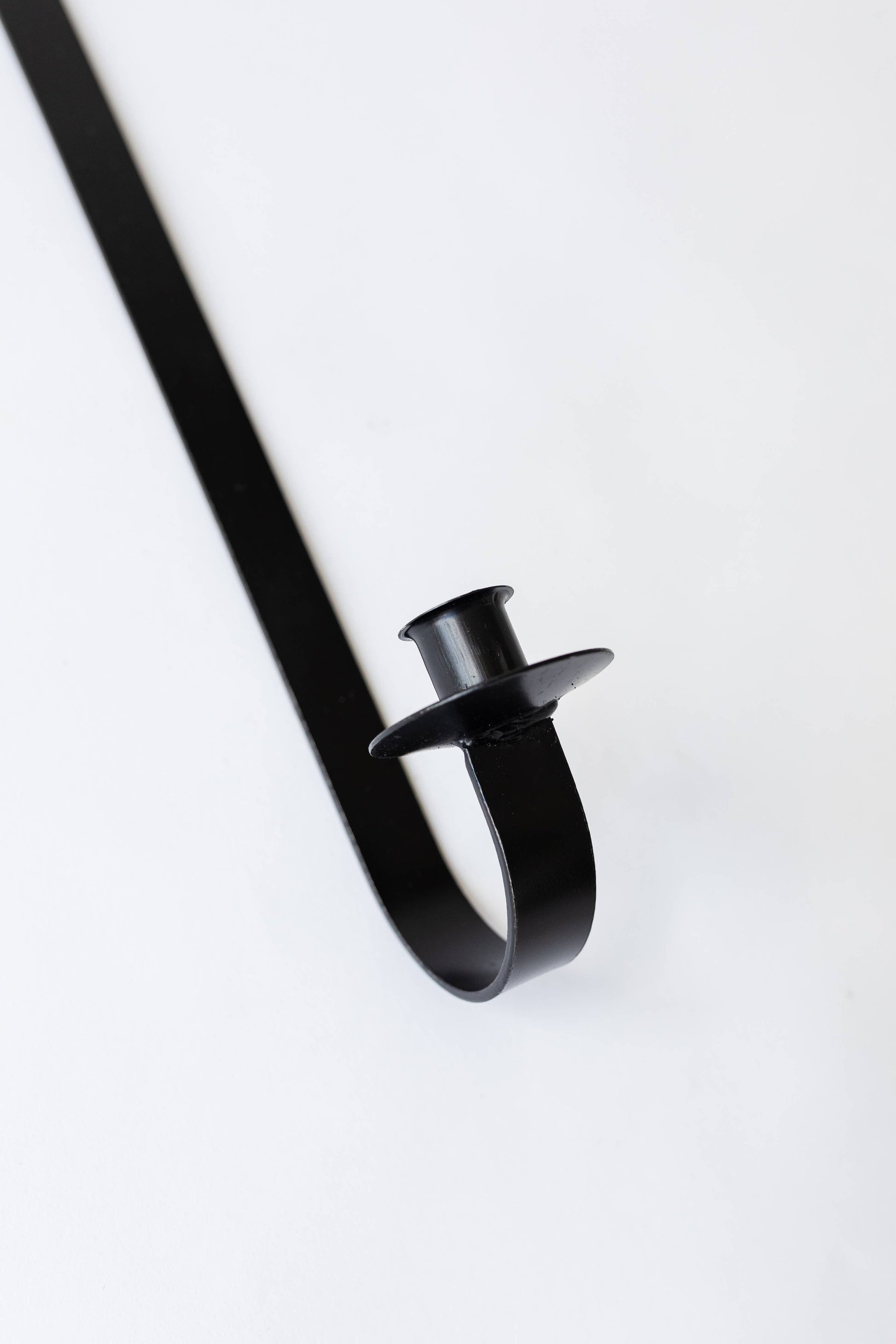closeup of black iron taper holder 