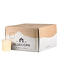 A single beeswax votive in the color ivory, sitting next to a closed 18-pack votive box