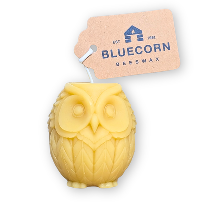 Raw natural beeswax owl shaped candle by Bluecorn, unlit, on a white background.