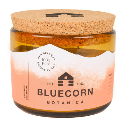 bluecorn candles scented 3-wick beeswax candle with essential oils of tangerine and geranium in a blown glass candle holder