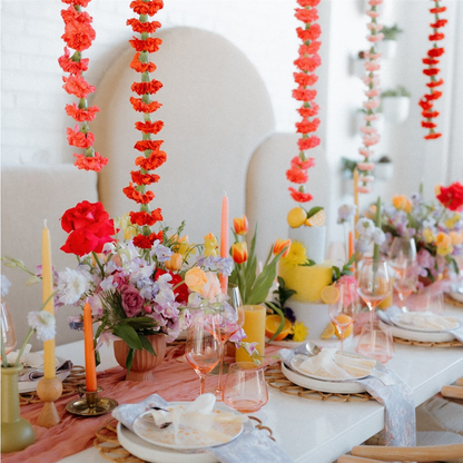 a boho wedding table featuring bluecorn candles green candlesticks, pink tapers, pure beeswax pillar candles
