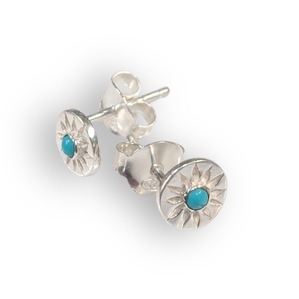 Silver earrings with turquoise stones on a white background