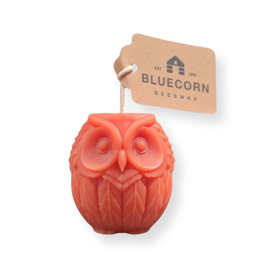 Terracotta owl shaped beeswax candle by Bluecorn, unlit, on a plain background.