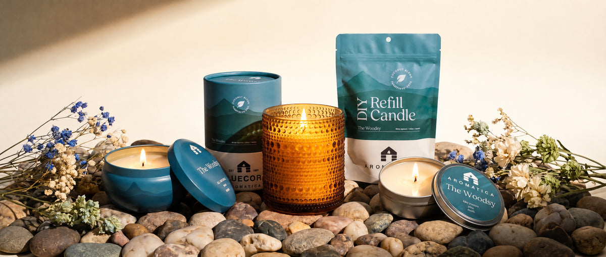 the full Bluecorn Aromática scented candle line in The Woodsy including full size scented candle tin, jar candle, sample tin and diy compostable candle refill kit.